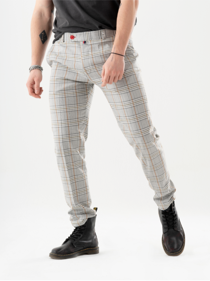 A man in a plaid shirt and ALORA PANTS is posing for a photo.