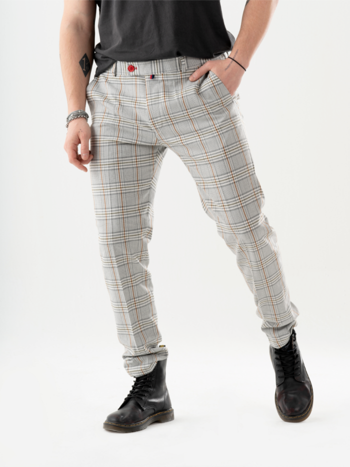 A man in a t-shirt and ALORA PANTS is standing in front of a white background.