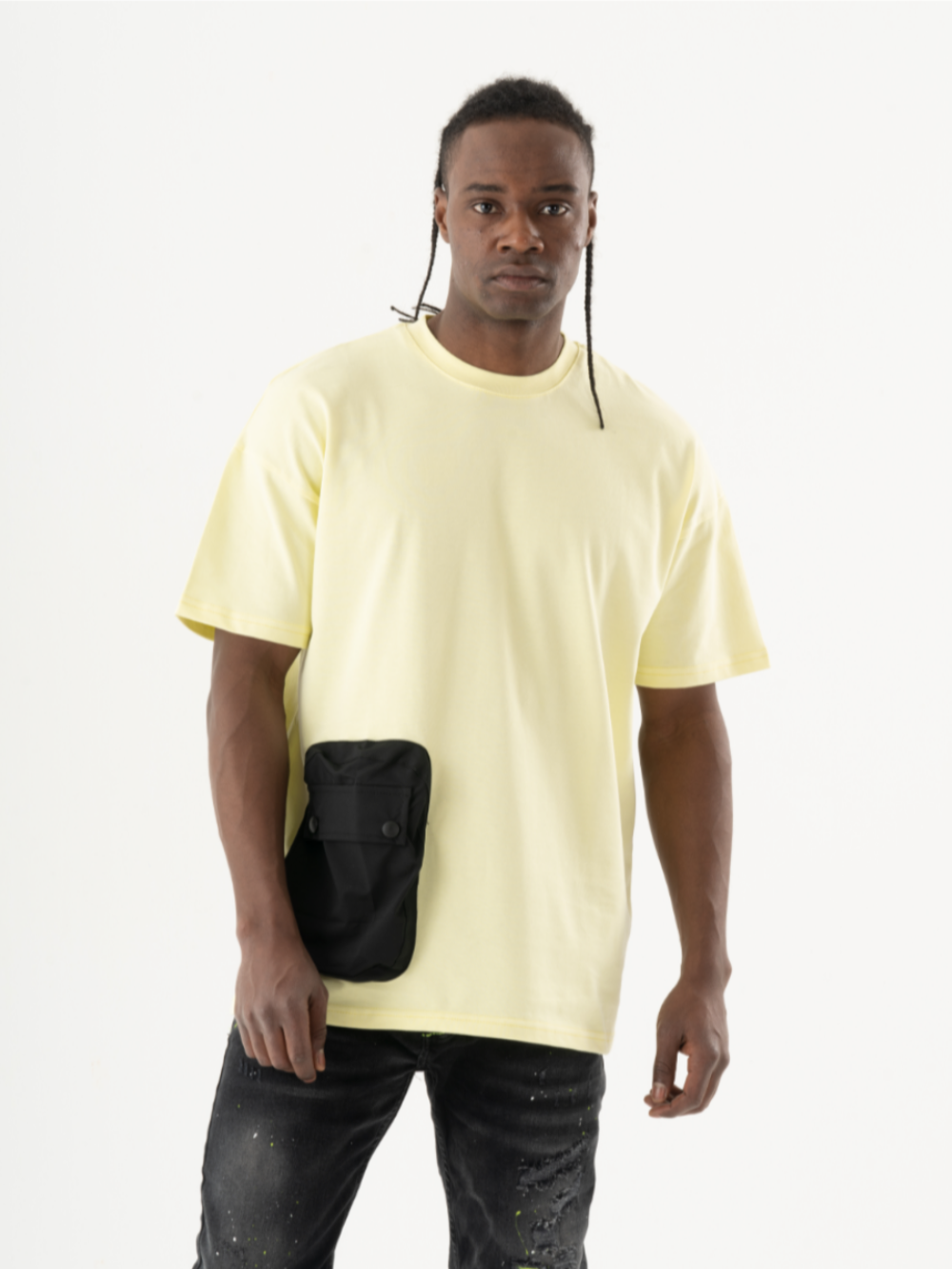 A person wearing a yellow SUNRAY T-SHIRT and black pants, with a black-buttoned pocket pouch attached to the T-shirt, stands against a plain white background.