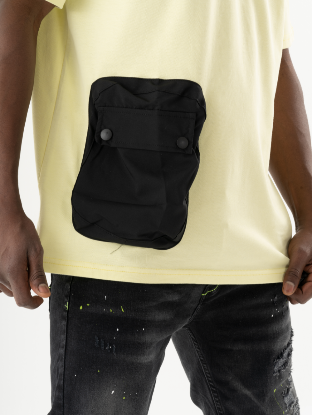 A man wearing a SUNRAY T-SHIRT with a black pocket, giving him a casual look.