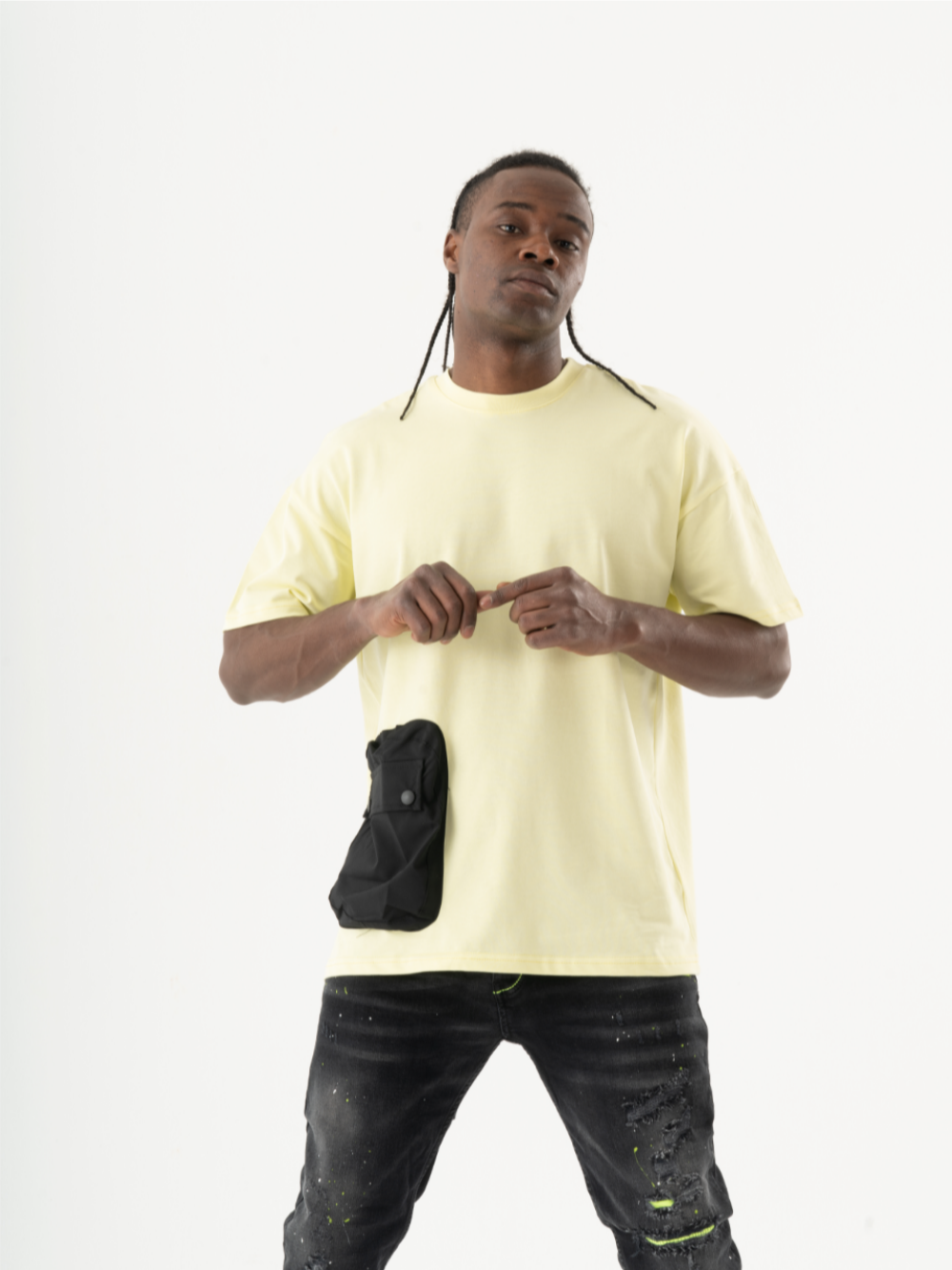 A man sporting a casual look in a crew neck yellow short sleeved SUNRAY T-SHIRT and black jeans.