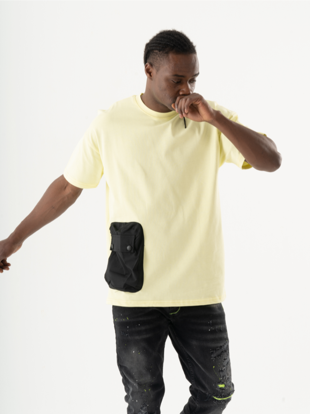 A man sporting a crew neck SUNRAY t-shirt and black jeans, creating a casual look.