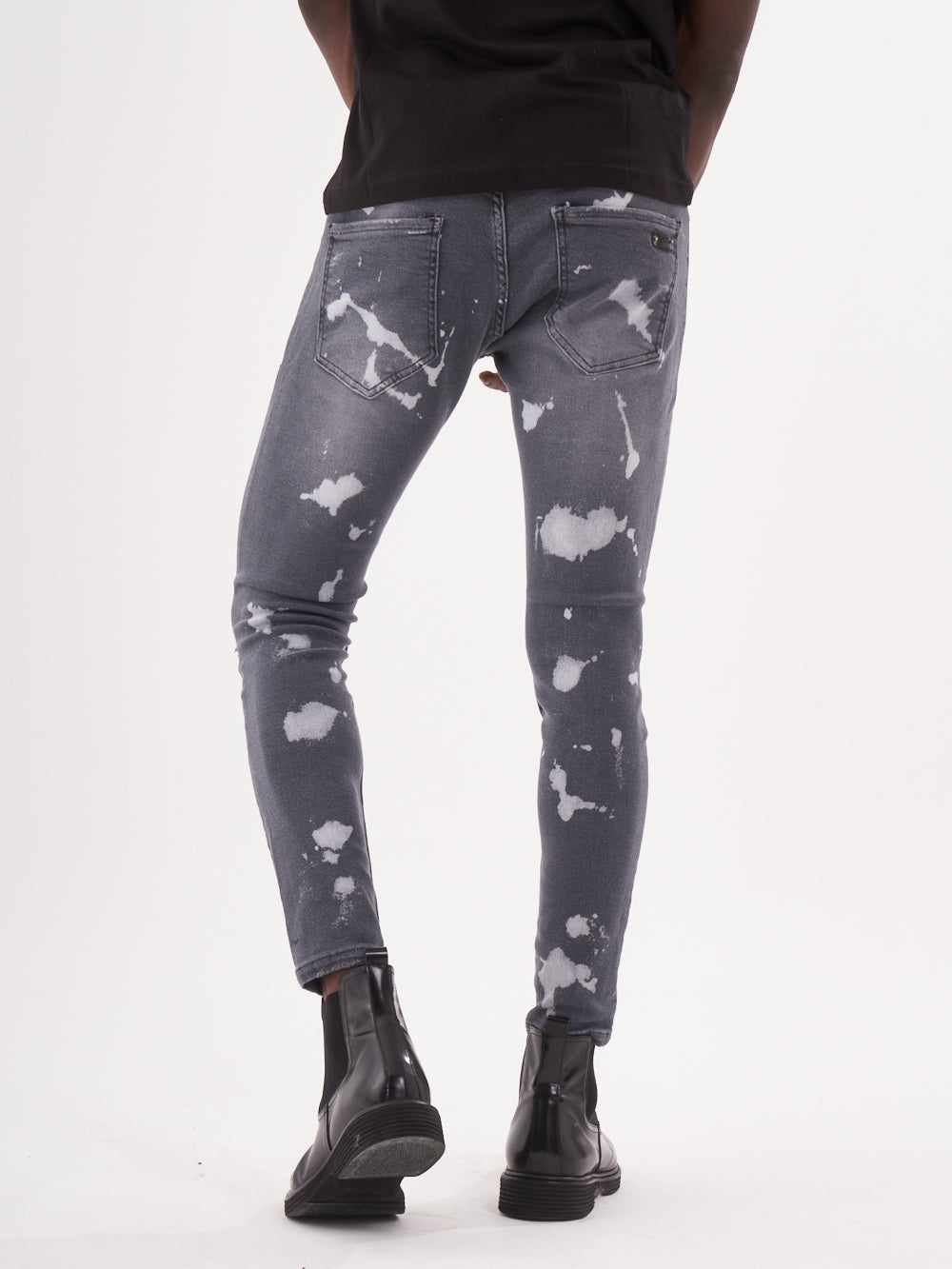 The back view of a man wearing MAVERICK jeans.