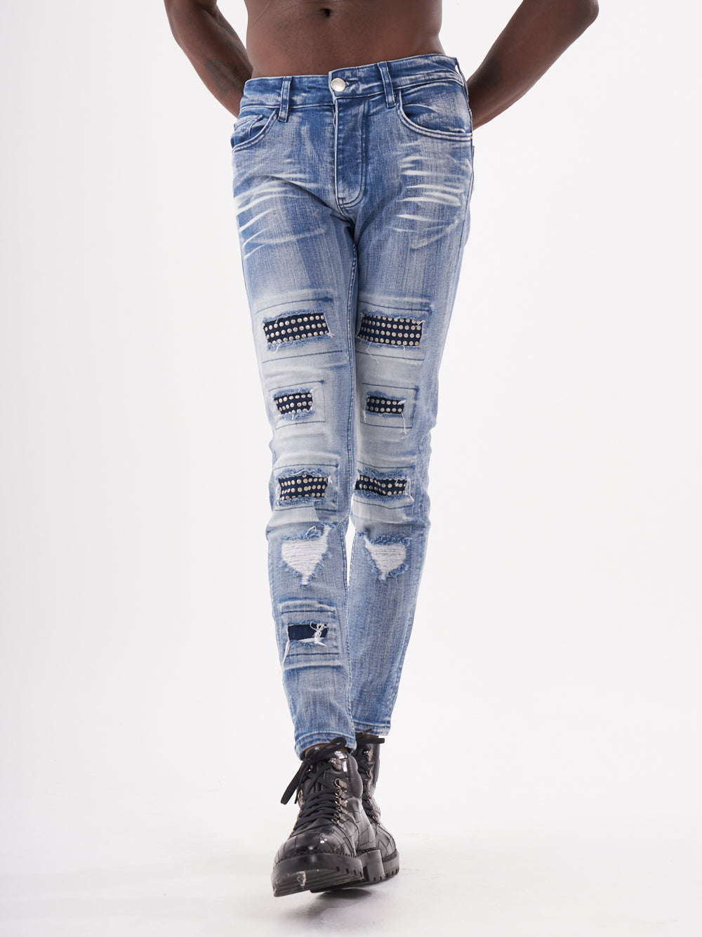 A man in a blue denim jean posing for a MUTANT photo.