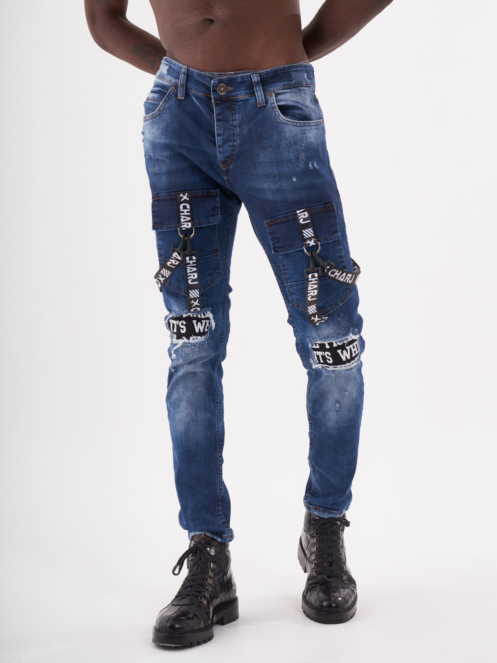 A man in TORNADO BLUE denim jean posing for a photo.