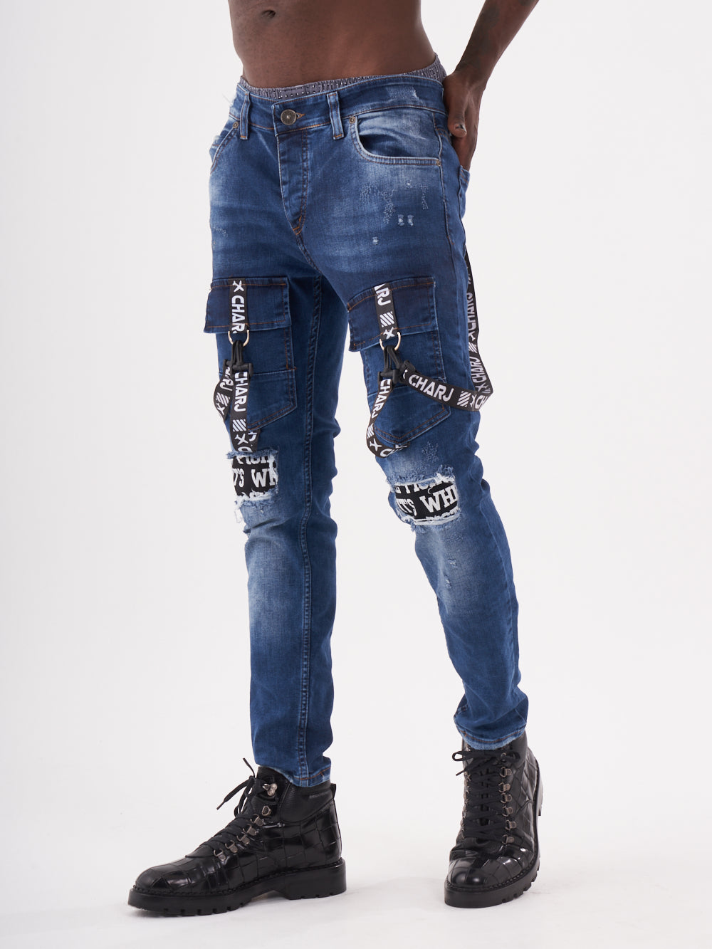 A man wearing a pair of TORNADO BLUE denim cargo pants.