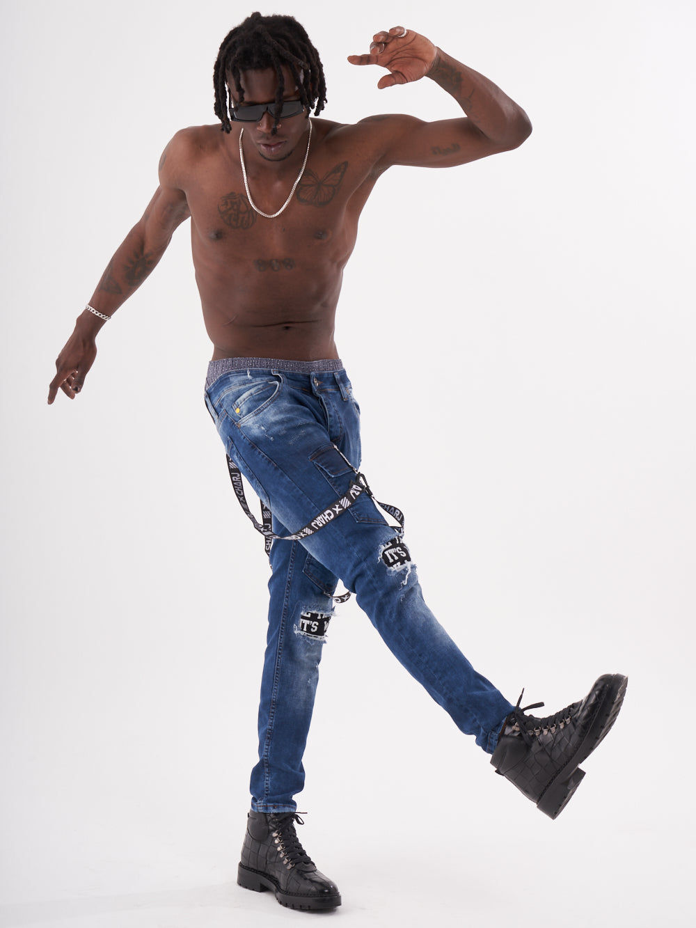 A TORNADO BLUE man in blue jeans and sneakers.
