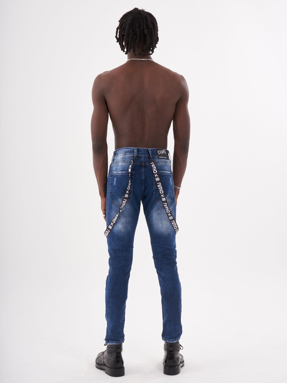 The back view of a man wearing TORNADO BLUE with chain straps.