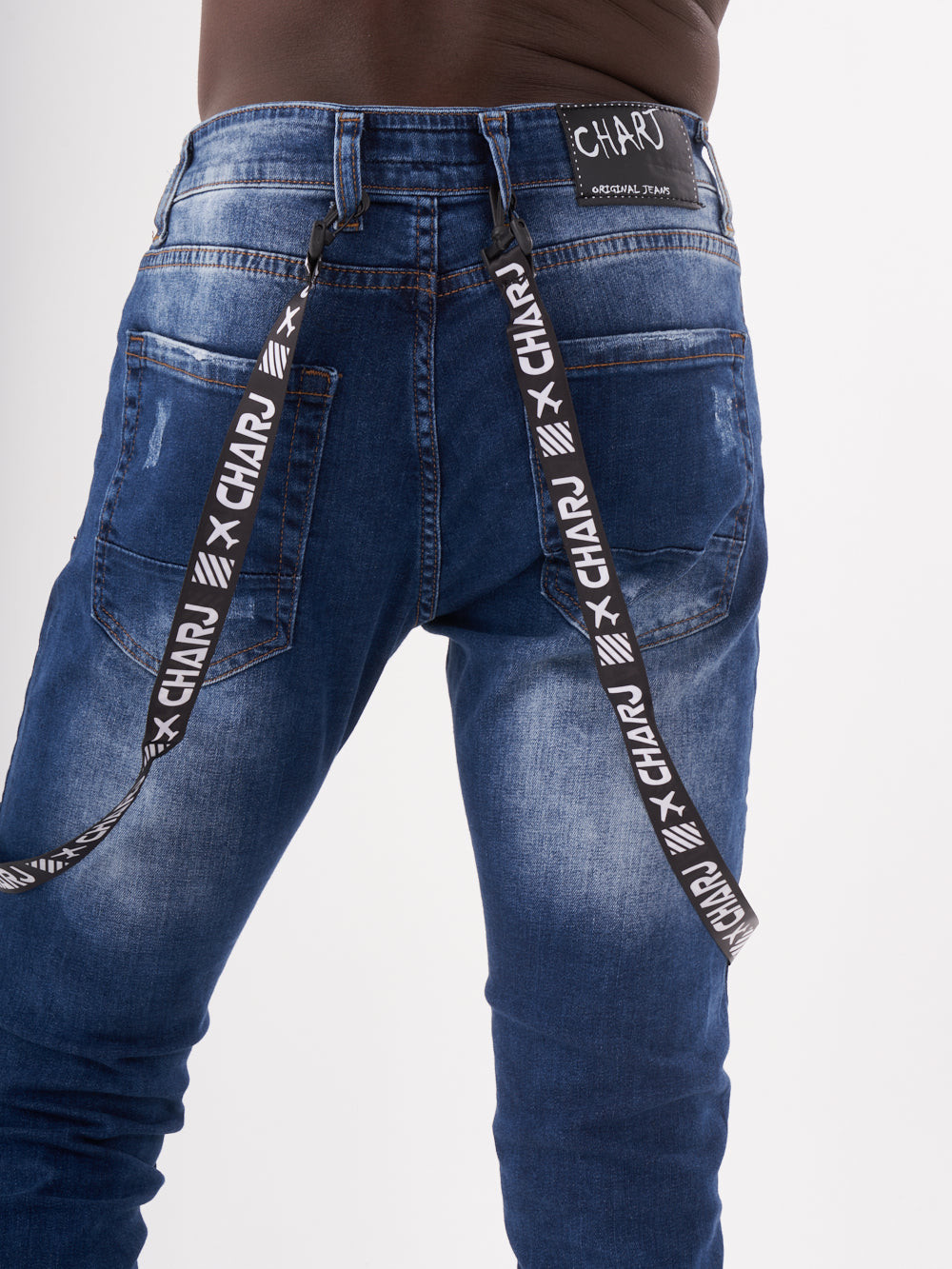The back of a man wearing TORNADO BLUE jeans with a belt.