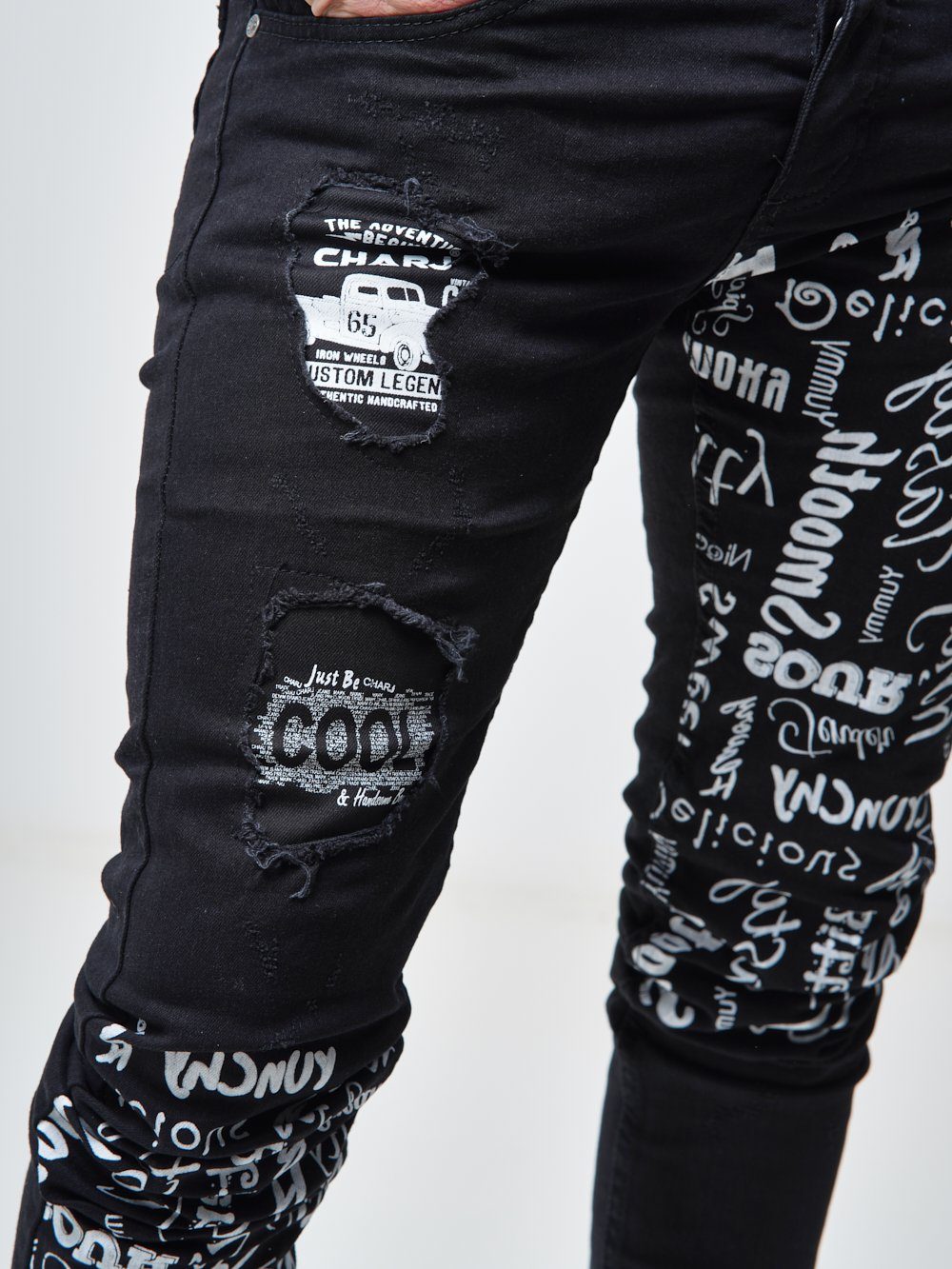Close up shot of the printed text on the skinny fit streetwear jeans called THE MECHANIC by SERNES with lots of text printed on it