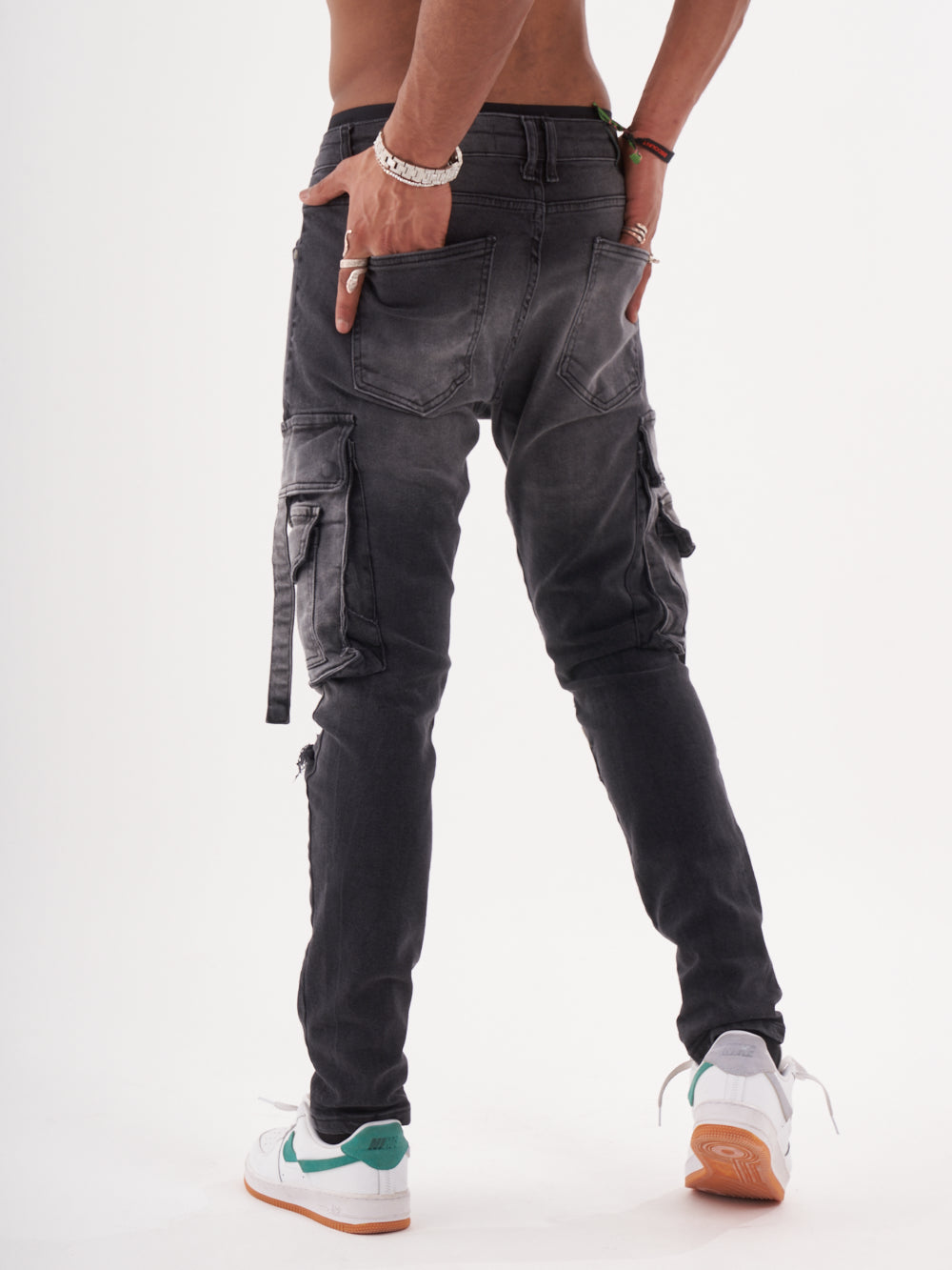 A man wearing HIPSTER pants and a white t-shirt.