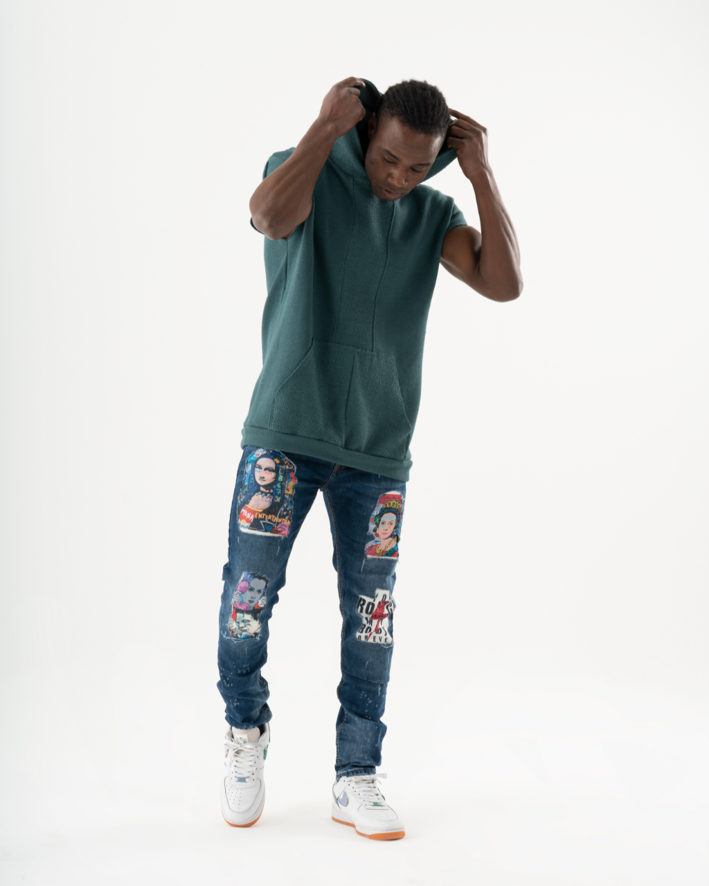 A man wearing ripped jeans attends a concert in a vibrant green CRESCENDO hoodie, embracing the essence of pop art.