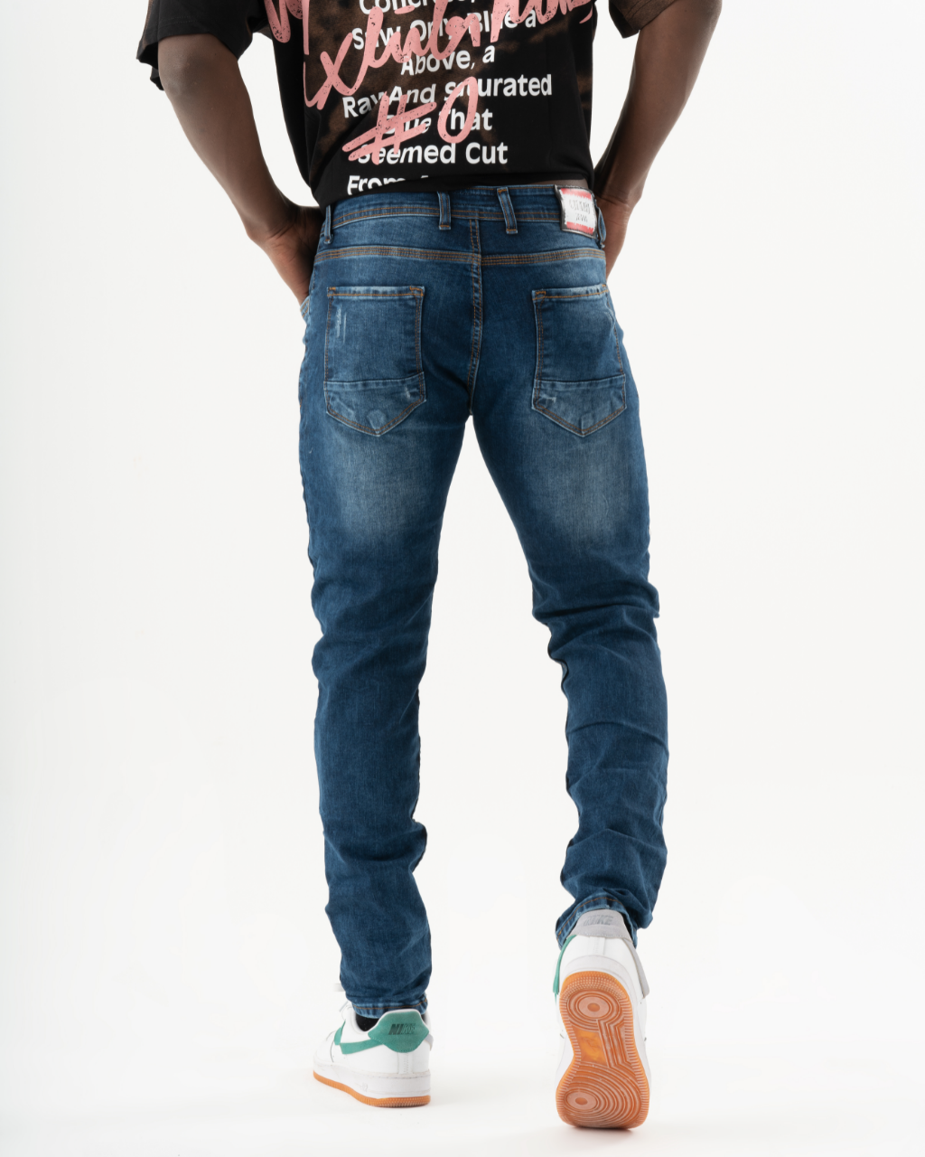 The back of a man wearing CRESCENDO jeans.