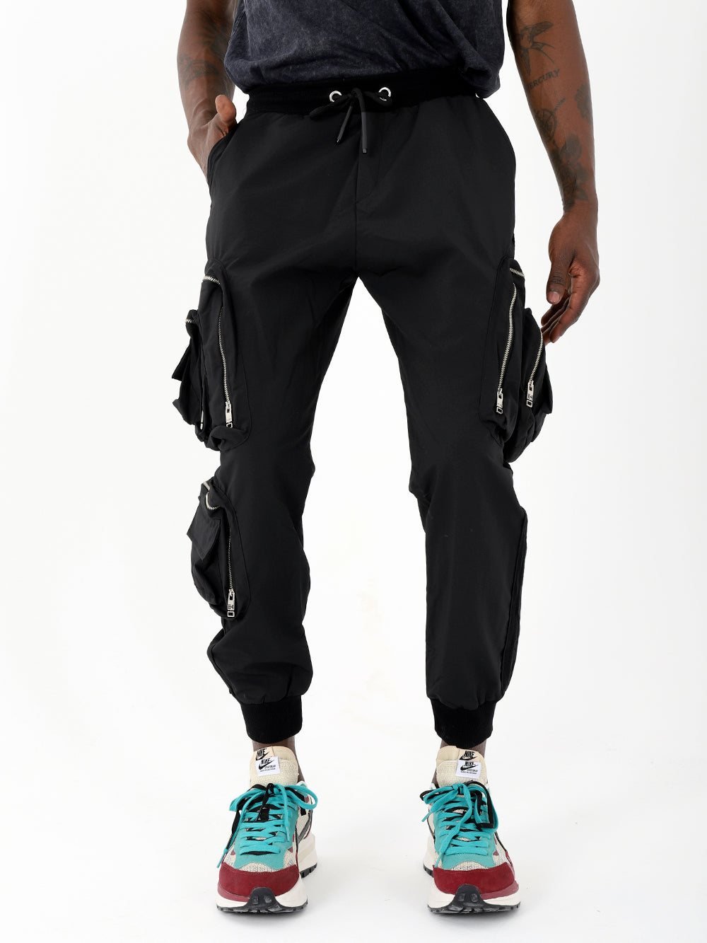 A man wearing black LAVANO joggers and sneakers.