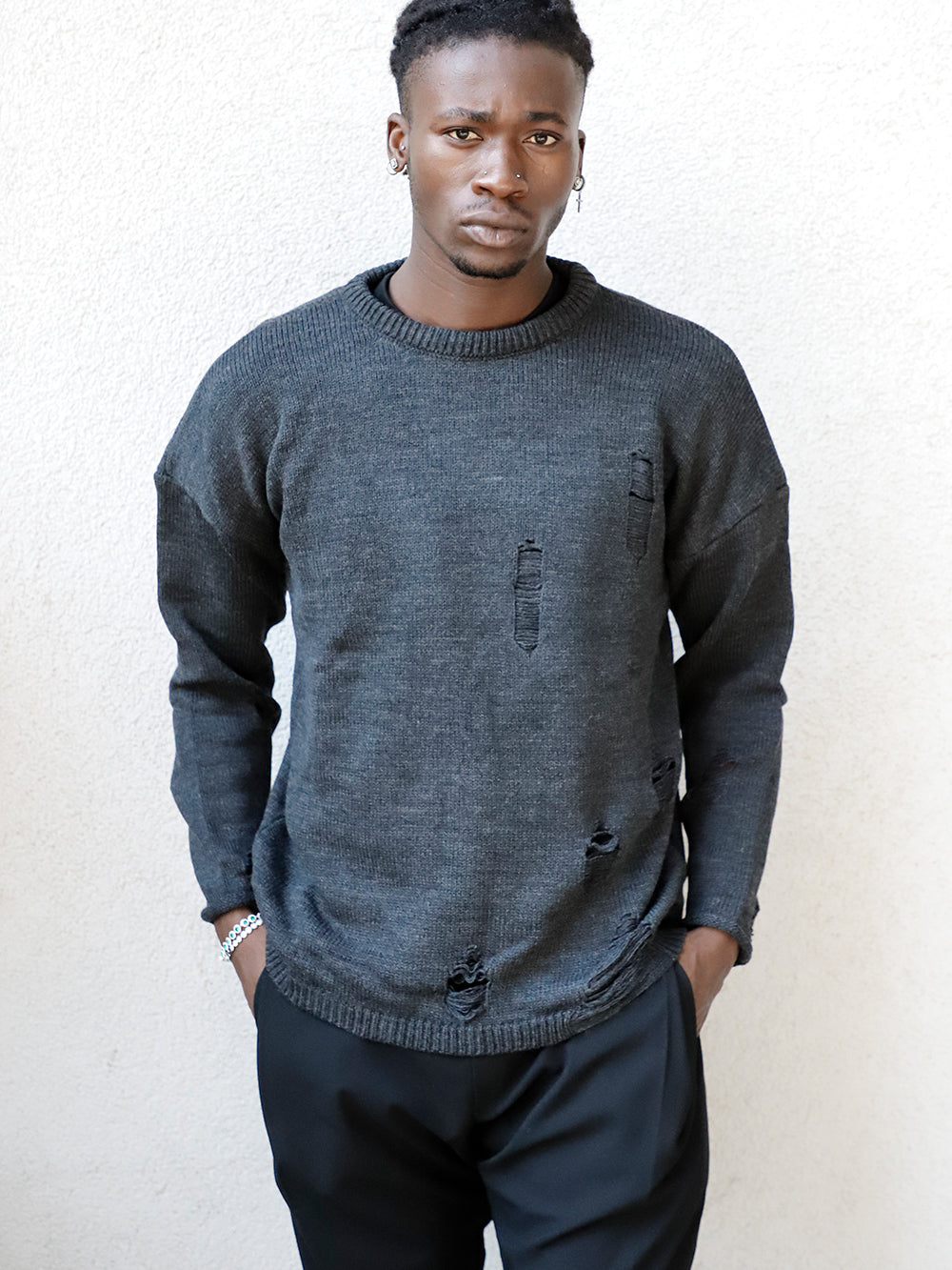 A man wearing a DISTRESSED GENTLEMAN SWEATER | CHARCOAL.