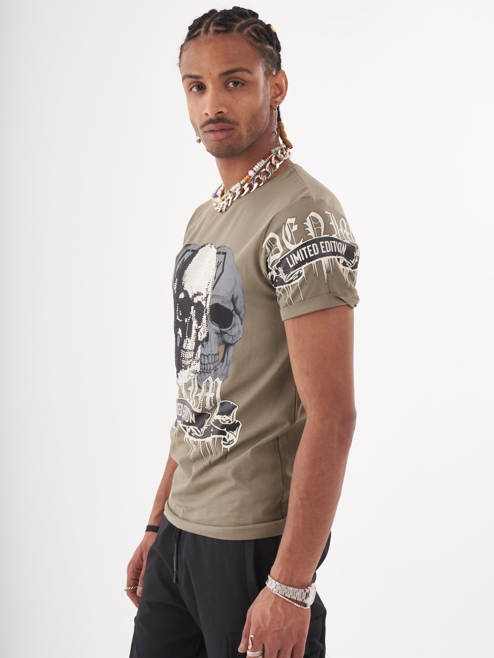 A man wearing the SKULL CRUSHER T-SHIRT | GREEN with a skull on it.