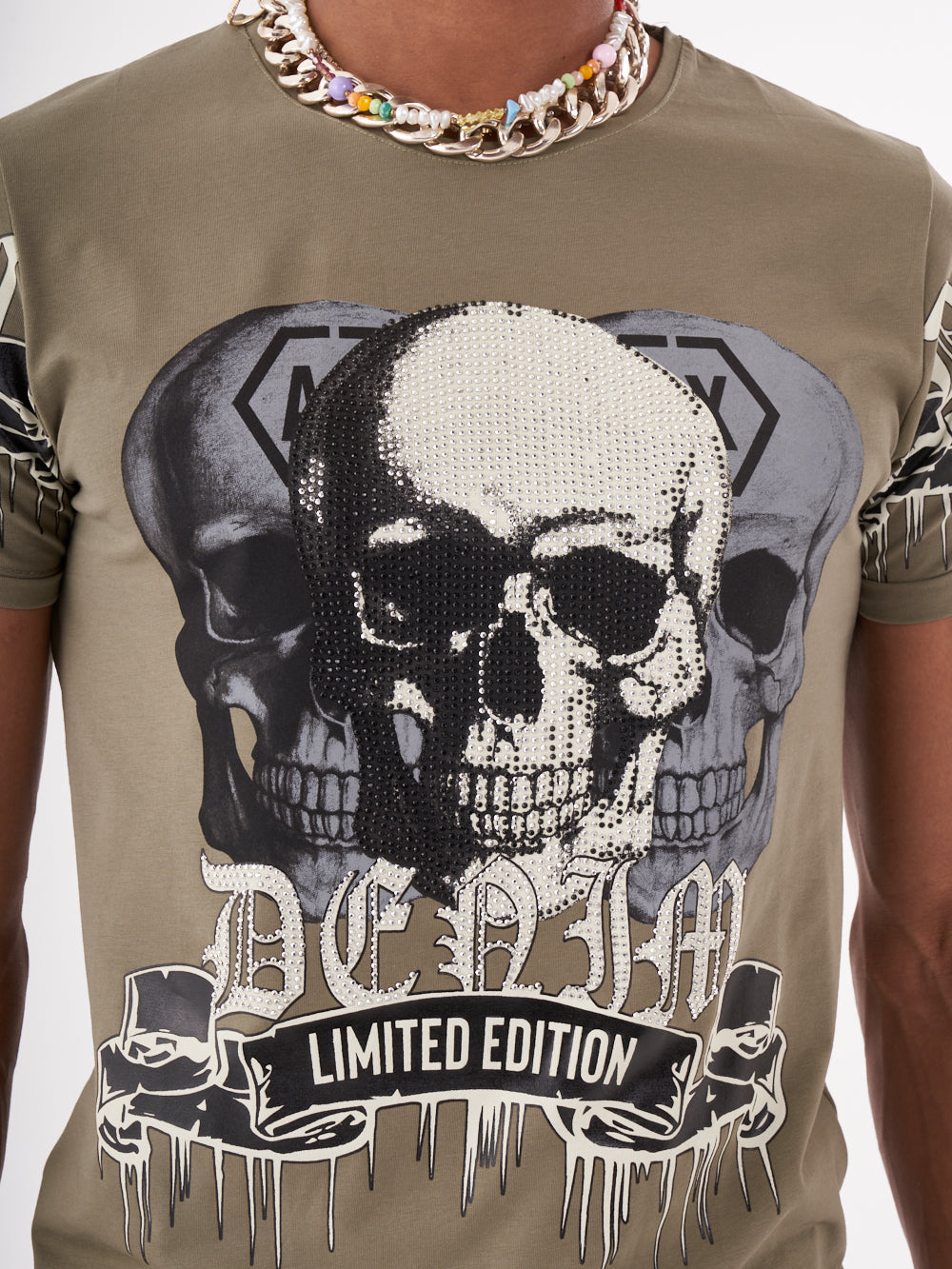 A man wearing a SKULL CRUSHER T-SHIRT | GREEN with skull graphics.