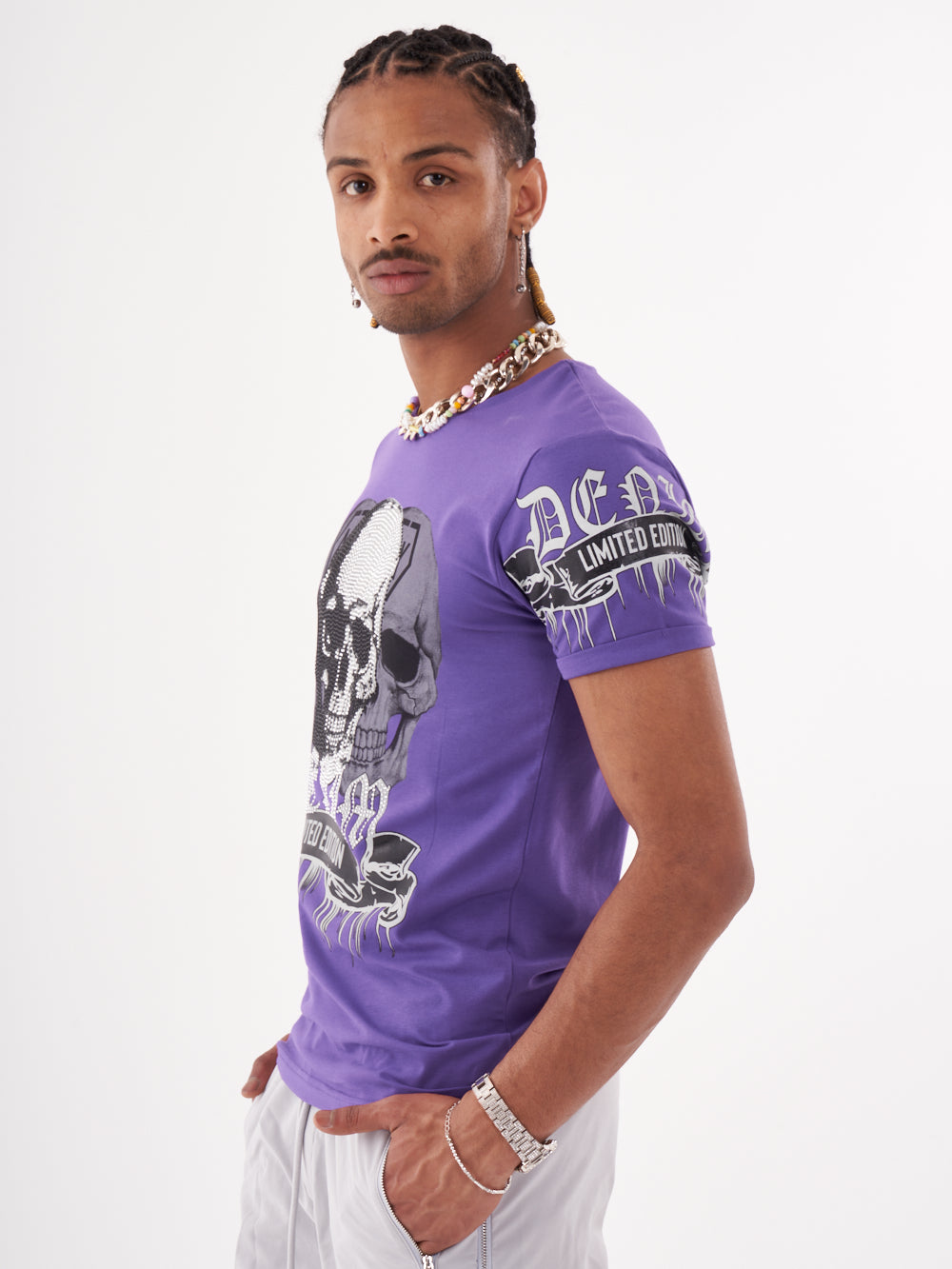 A man wearing a SKULL CRUSHER T-SHIRT | PURPLE.