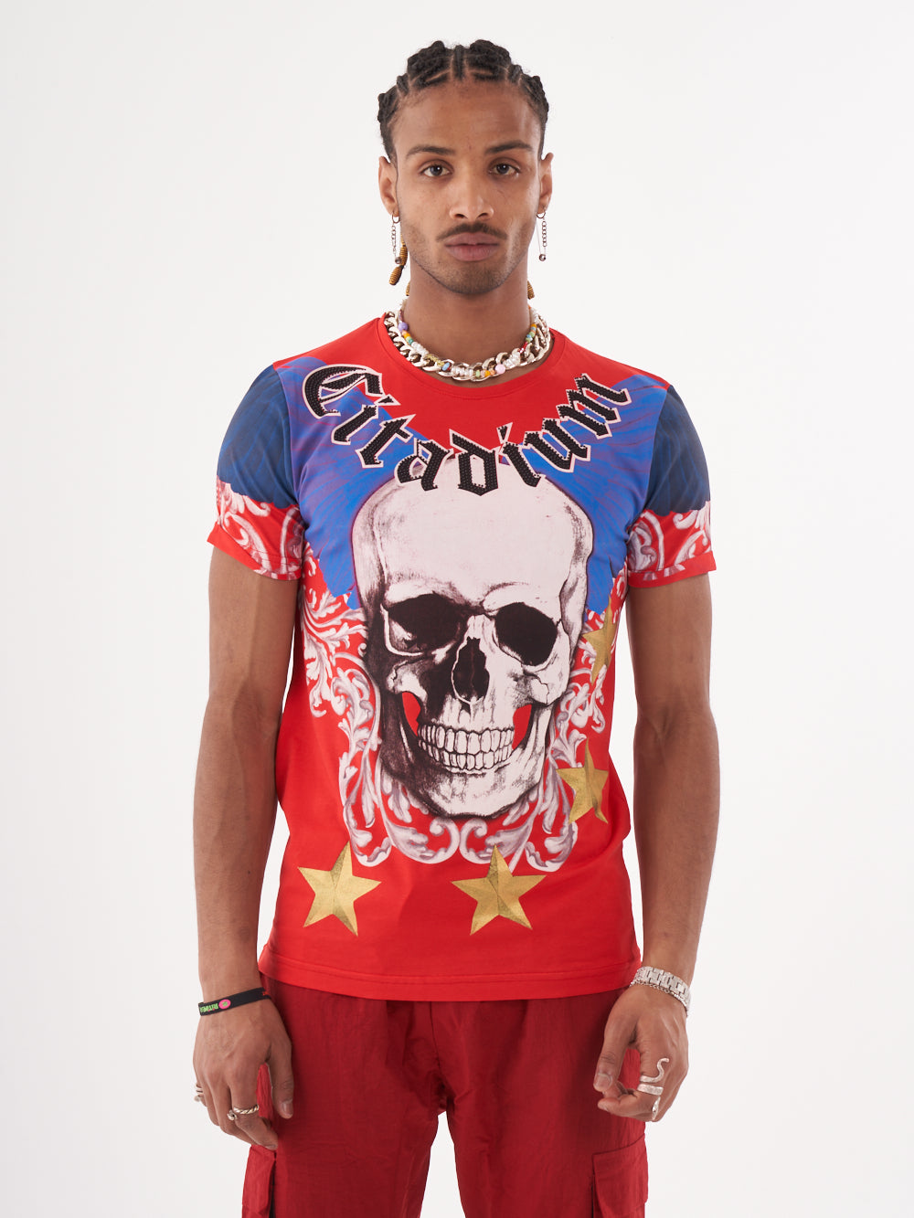 A man wearing a EUPHORIA T-SHIRT | RED with a bold design featuring a skull.