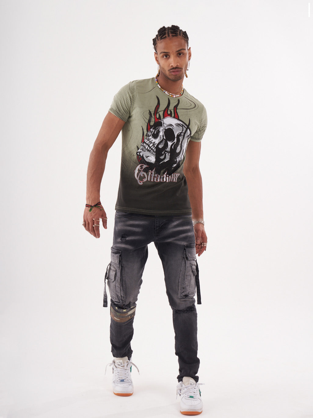 A man wearing a NIRVANA T-SHIRT | GREEN and jeans.
