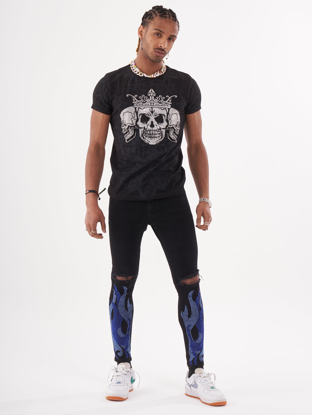 A man wearing a TRINITY T-SHIRT | BLACK with a skeleton print.