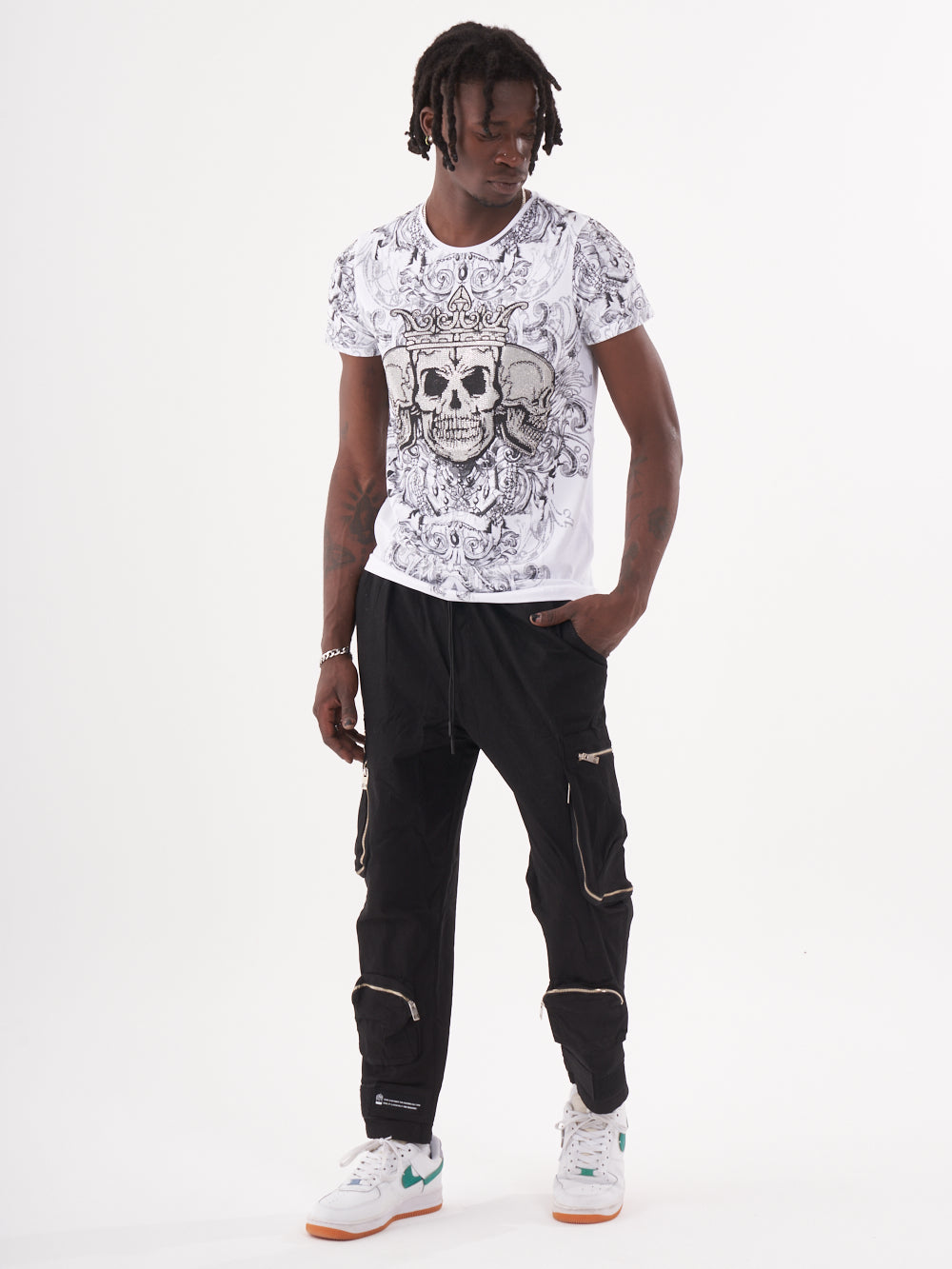 A man with an edgy style, wearing a gothic-inspired TRINITY T-SHIRT | WHITE and black cargo pants.