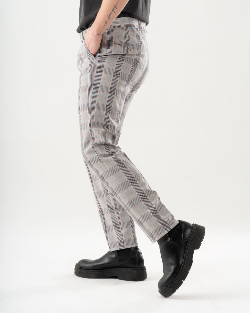 A man in KIKR PANTS is standing on a white background.