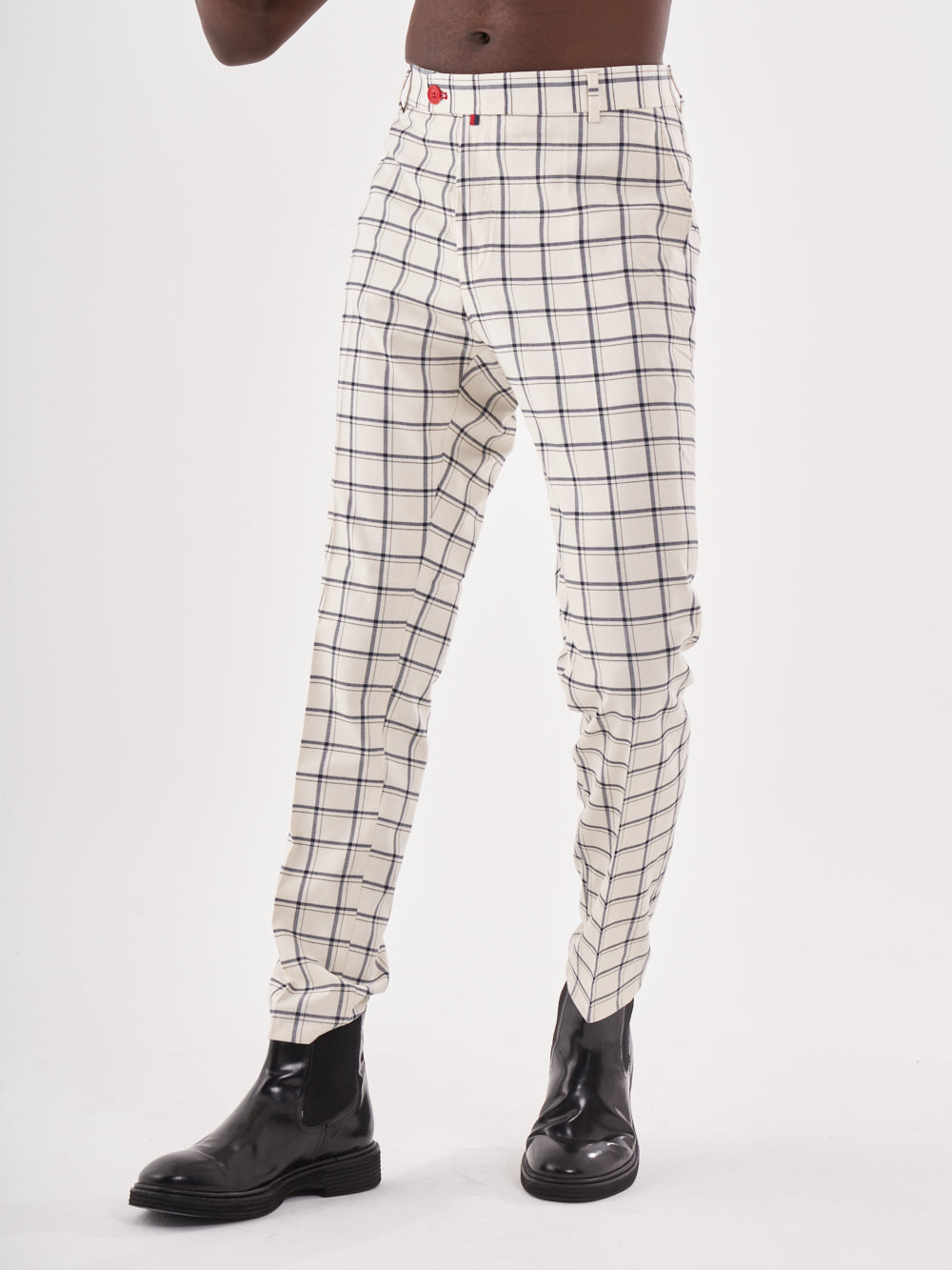 A man wearing TIMONO pants, white and black checkered.