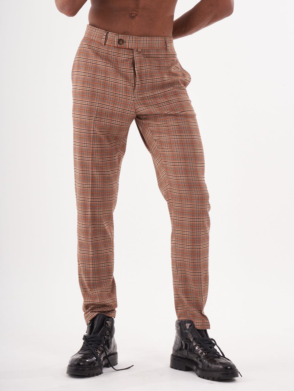A man in sawdust pants posing for a photo.