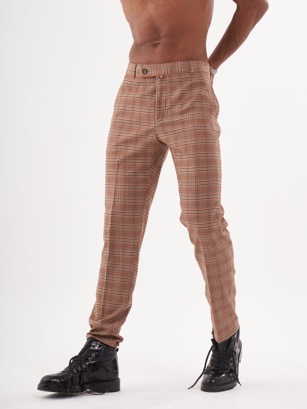 A man in sawdust pants posing for a photo.