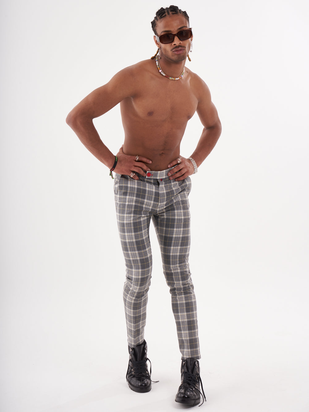 A man in a plaid shirt and CHECKMATE PANTS posing for a photo.