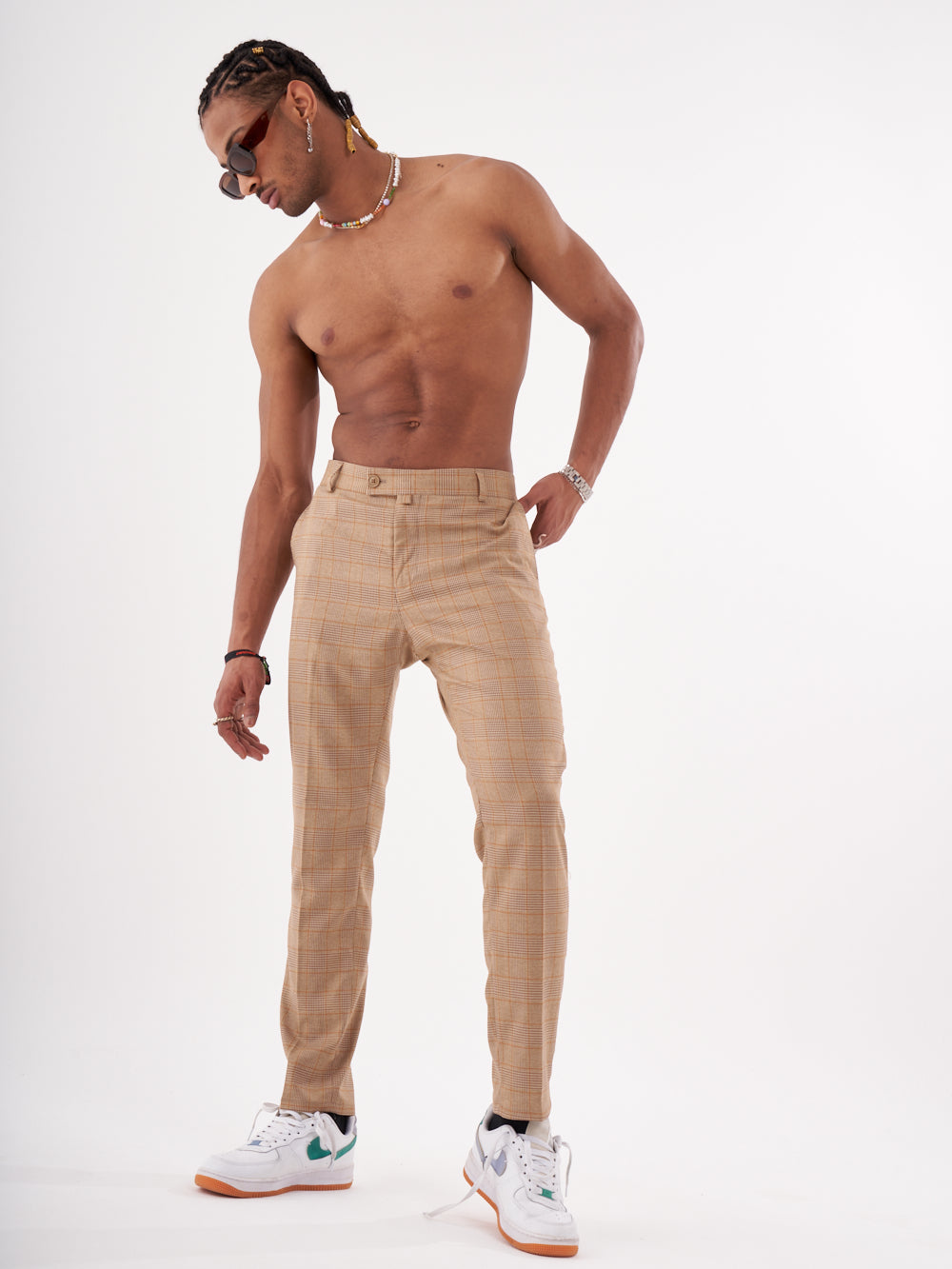A man in BAROT pants is posing for a photo.