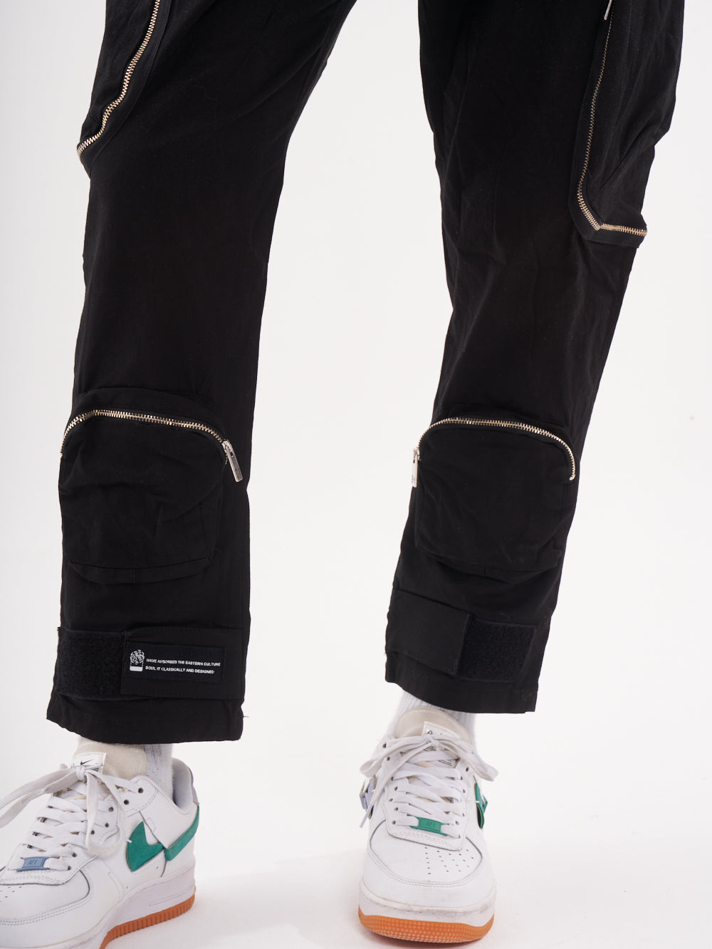A man wearing a pair of RAIDER JOGGERS and sneakers.
