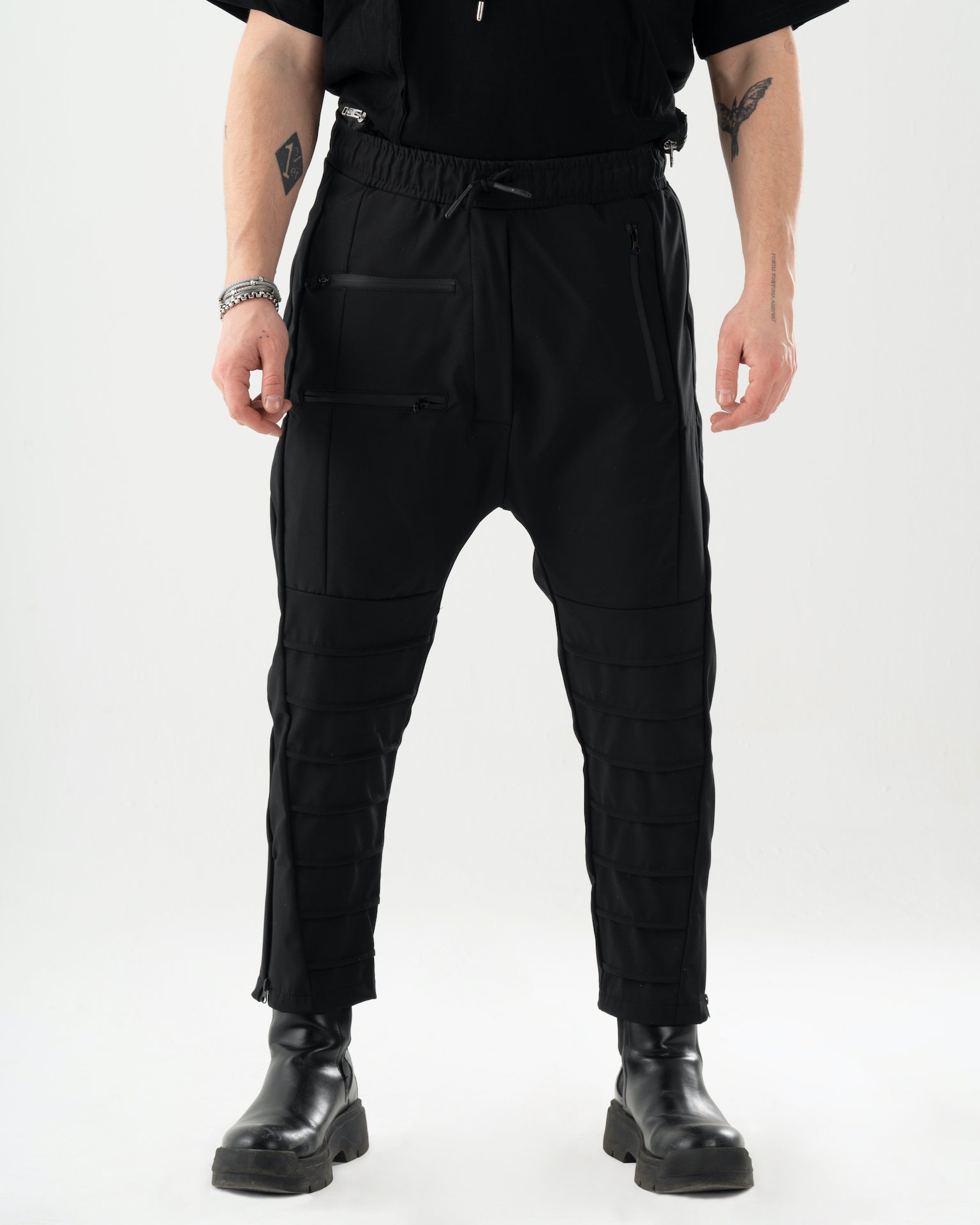 A man wearing INVOGUE joggers and a black t-shirt.