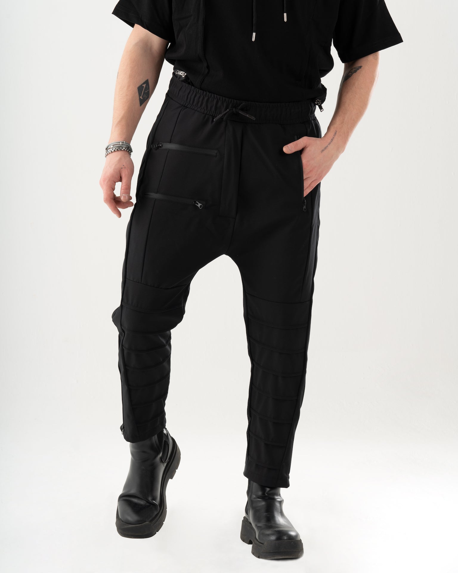 A man wearing INVOGUE JOGGERS and a black t - shirt.