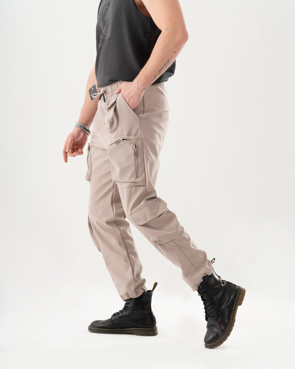 A man in a comfortable black tank top and AMBITION JOGGERS, showcasing style and function.