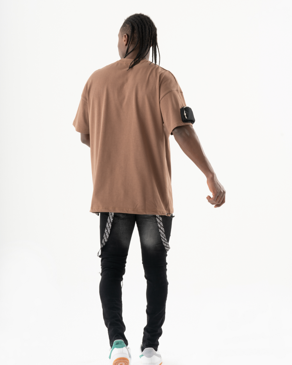 The back of a man wearing a FATE t-shirt.