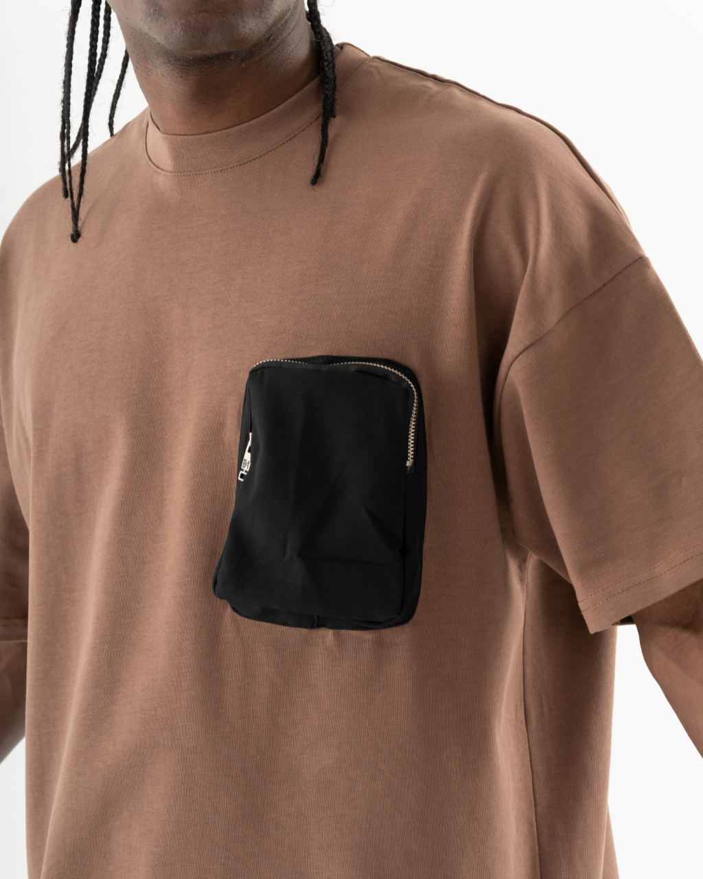 A man wearing a FATE T-SHIRT with a black pocket.