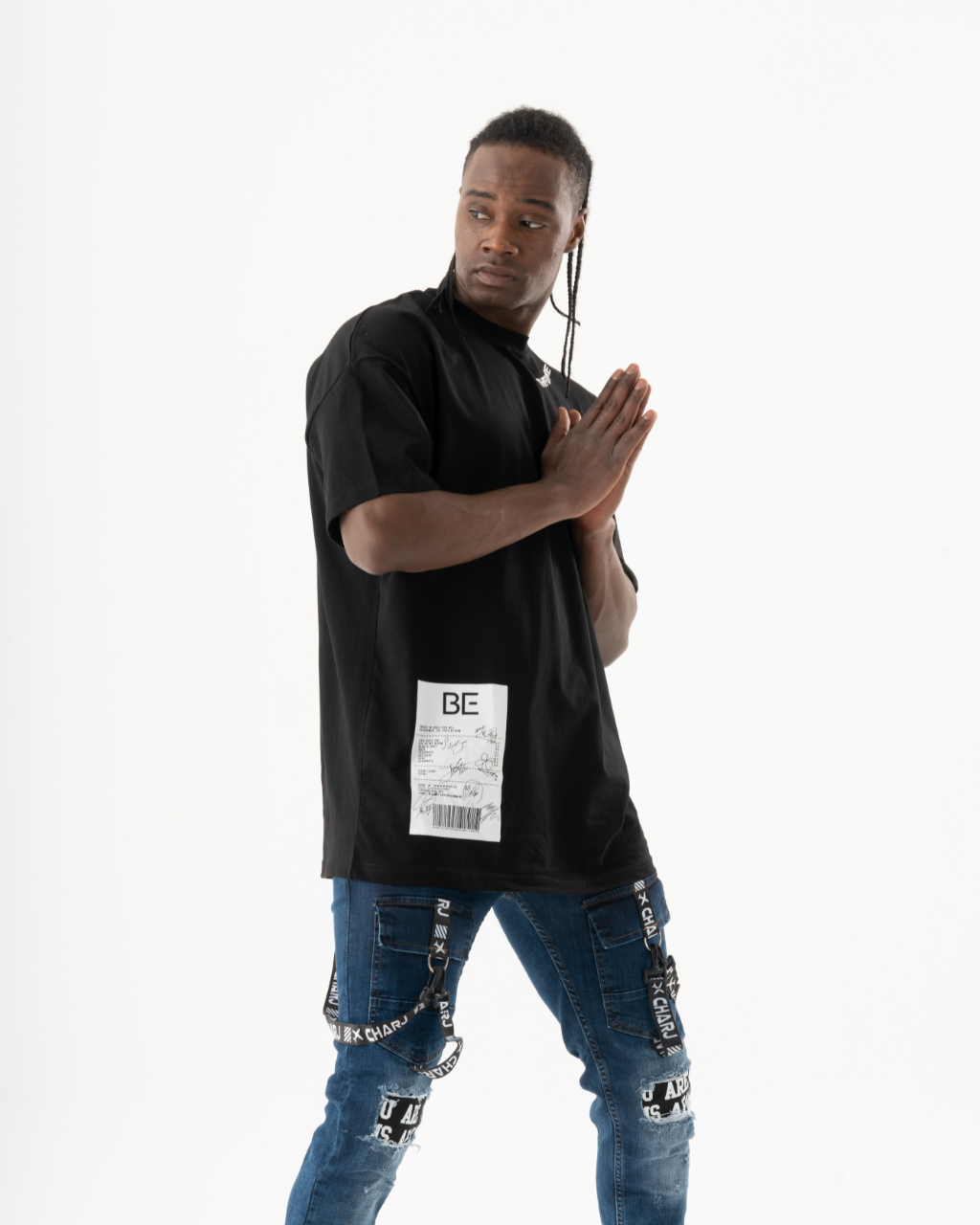 A relaxed man in a TURRET T-SHIRT and jeans posing for a photo.
