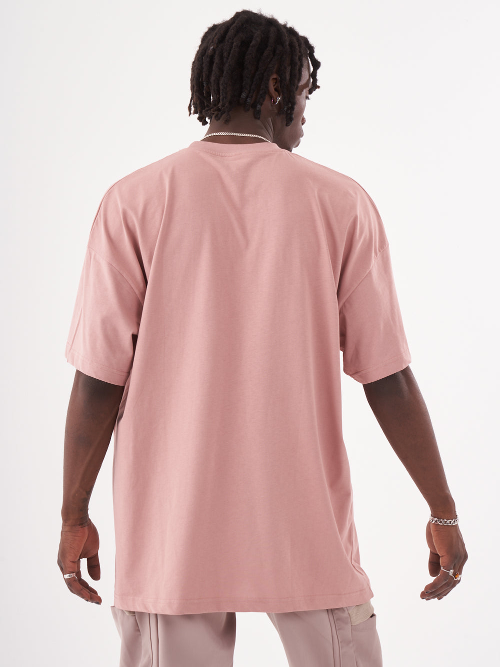 The back of a man wearing a CREED T-SHIRT.