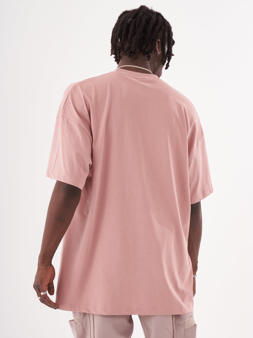 The back of a man wearing a CREED T-SHIRT.