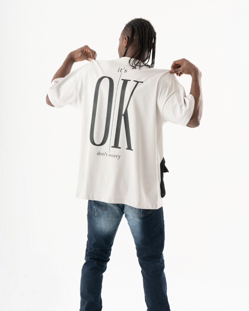 A man wearing an ELEVATE t-shirt with the word ok on it.