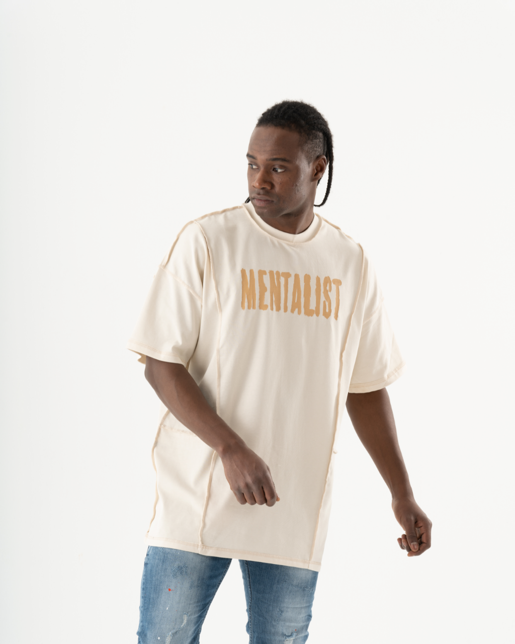 A man wearing a Mentalist T-shirt in beige.