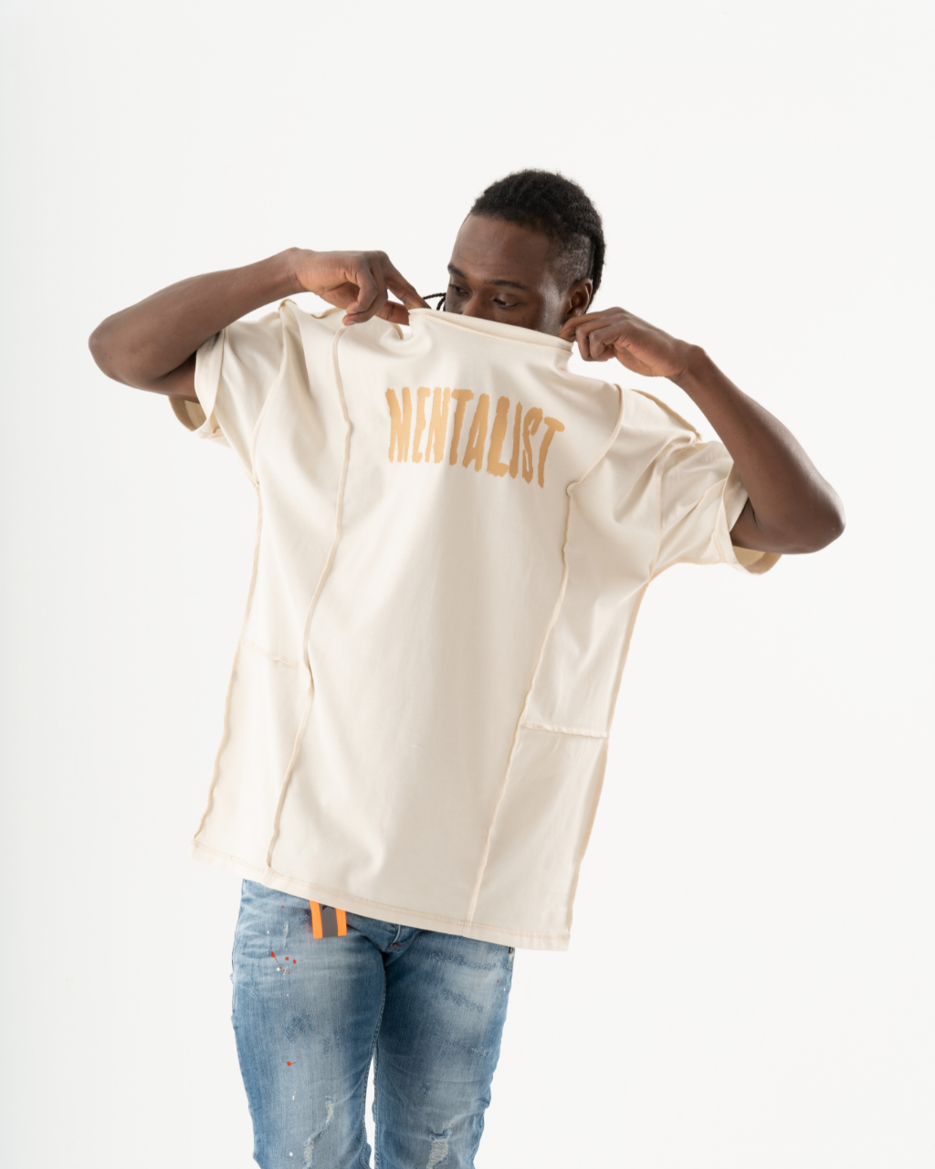 A man wearing a white t-shirt with the word "MENTALIST" on it.