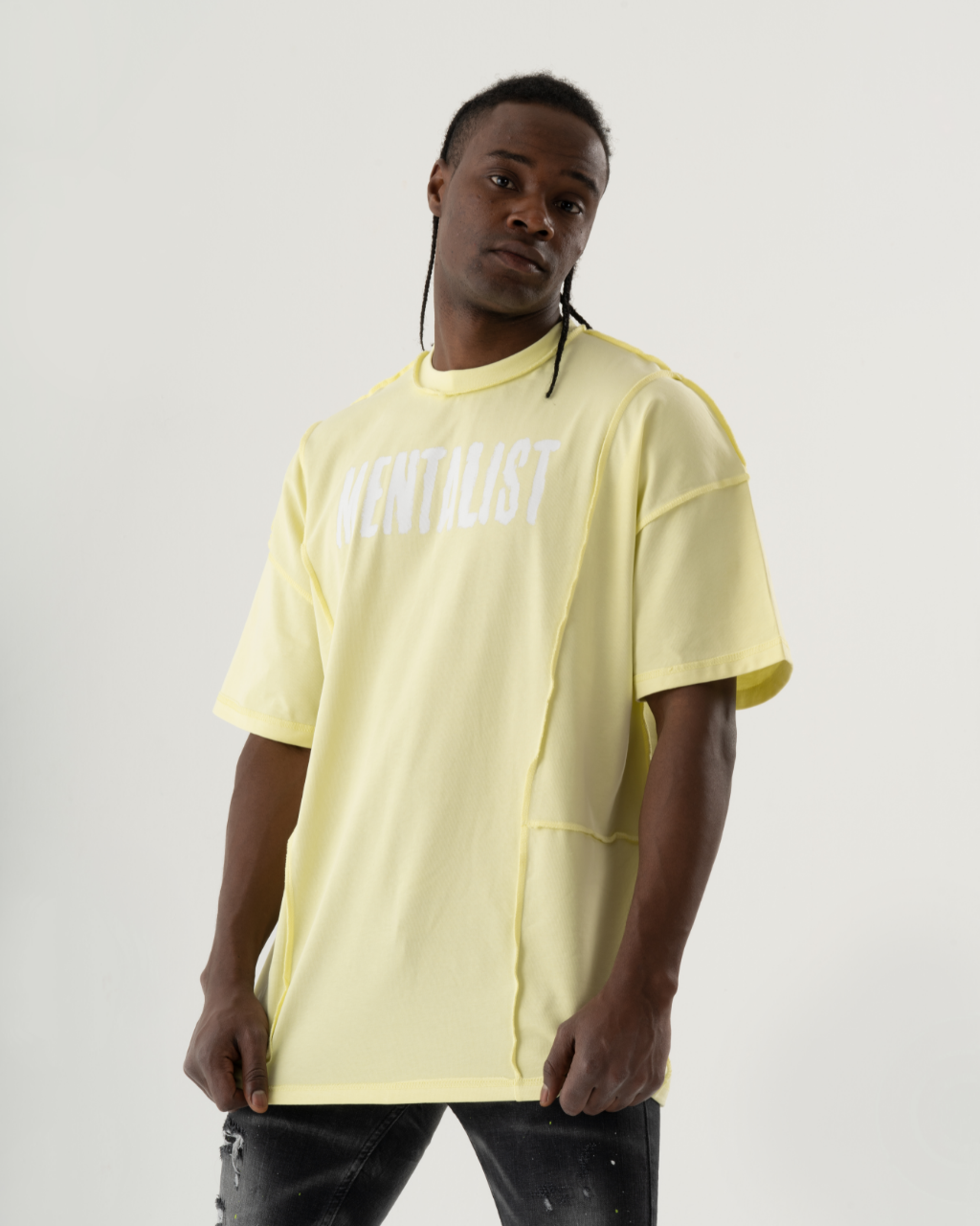 A man wearing a summery yellow MENTALIST T-SHIRT | LIME and casual jeans.