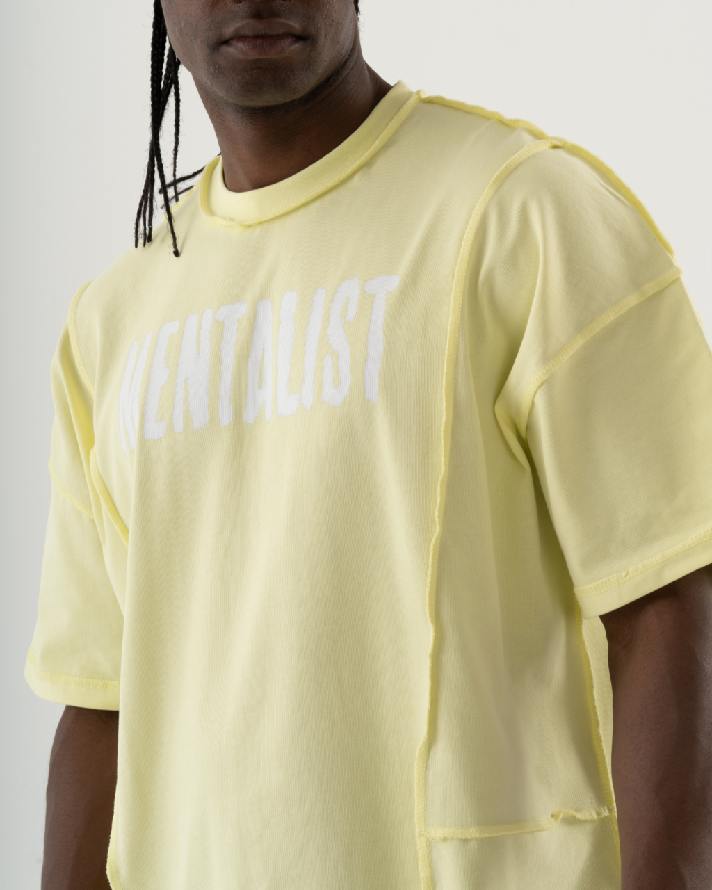 A casual man wearing a summery yellow MENTALIST T-SHIRT | LIME with the word mentalist on it.