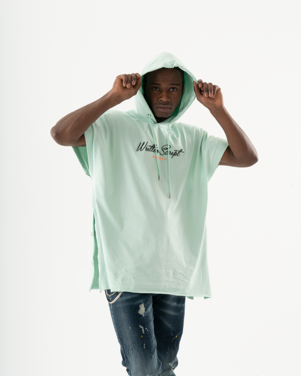 A man wearing an EXPLORER HOODIE, known for its soft feel and comfort fit, and jeans.