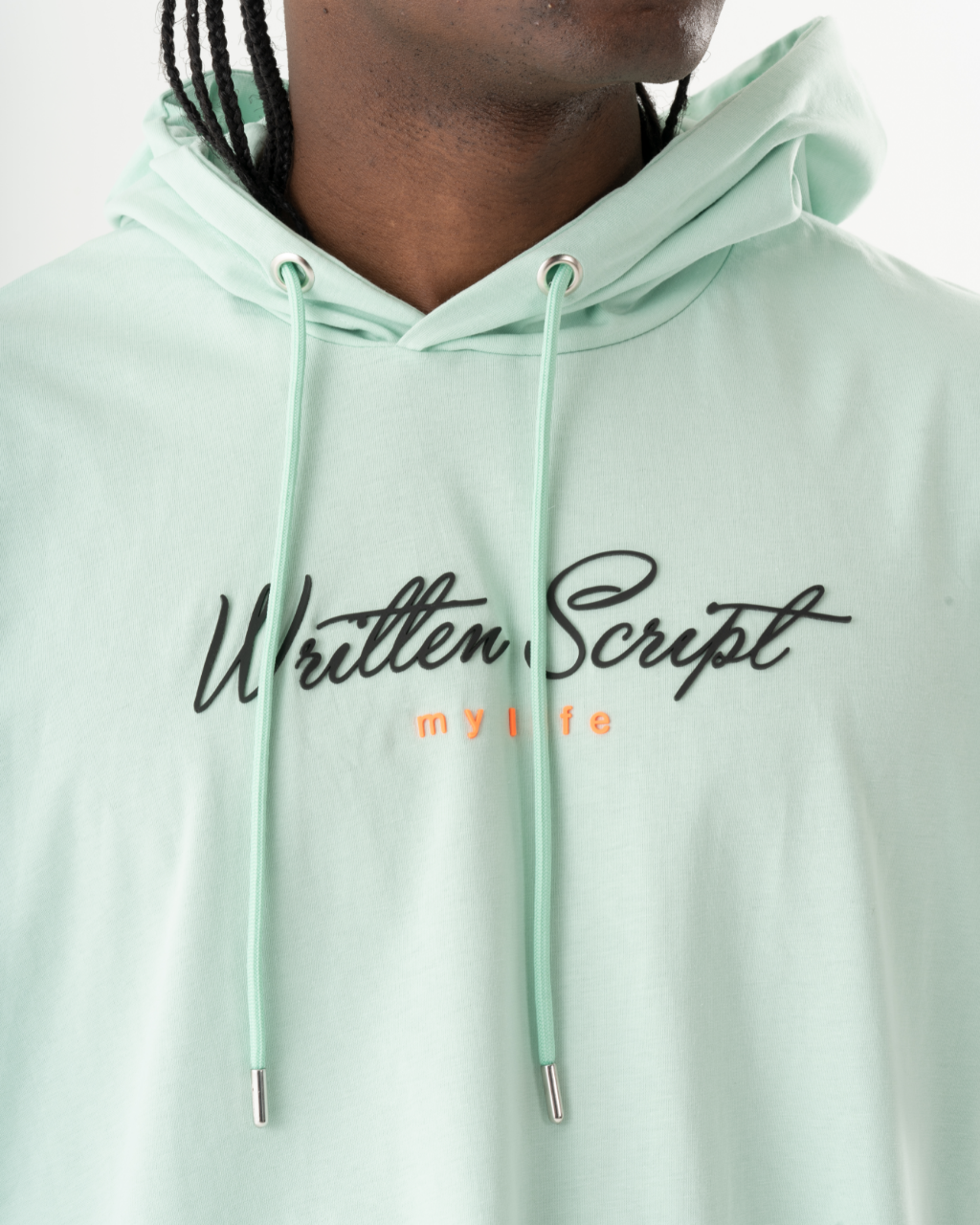 A man wearing an EXPLORER HOODIE in mint green.