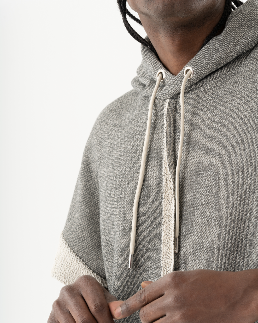 A black man wearing a grey HAILMARY HOODIE hoodie.