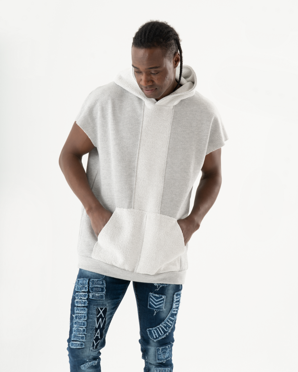 A black man wearing a BACHELOR HOODIE | WHITE and jeans.